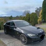 Black BMW parked on driveway